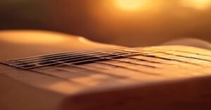 A close up view of a guitar neck and strings in a bright, minimalist room.