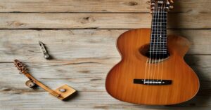 A close-up view of a digital guitar tuner attached to the headstock of an acoustic guitar.