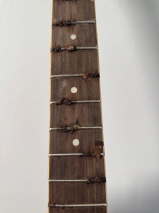 Rusty guitar frets before restoration