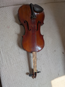Old broken violin awaiting professional appraisal