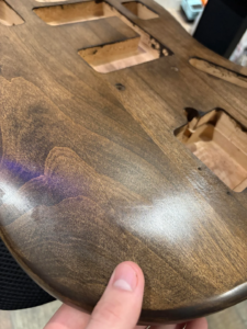 Tru-Oil streaks visible after the first coat on a guitar body