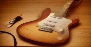 An electric guitar setup on a wooden desk for learning how to play power chords.