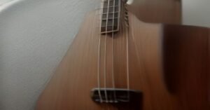 A close-up view of the strings on an acoustic guitar.