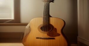 An acoustic guitar sitting in a sunlit room.
