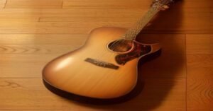 A flat lay of guitar gear including strings, picks, and a tuner.